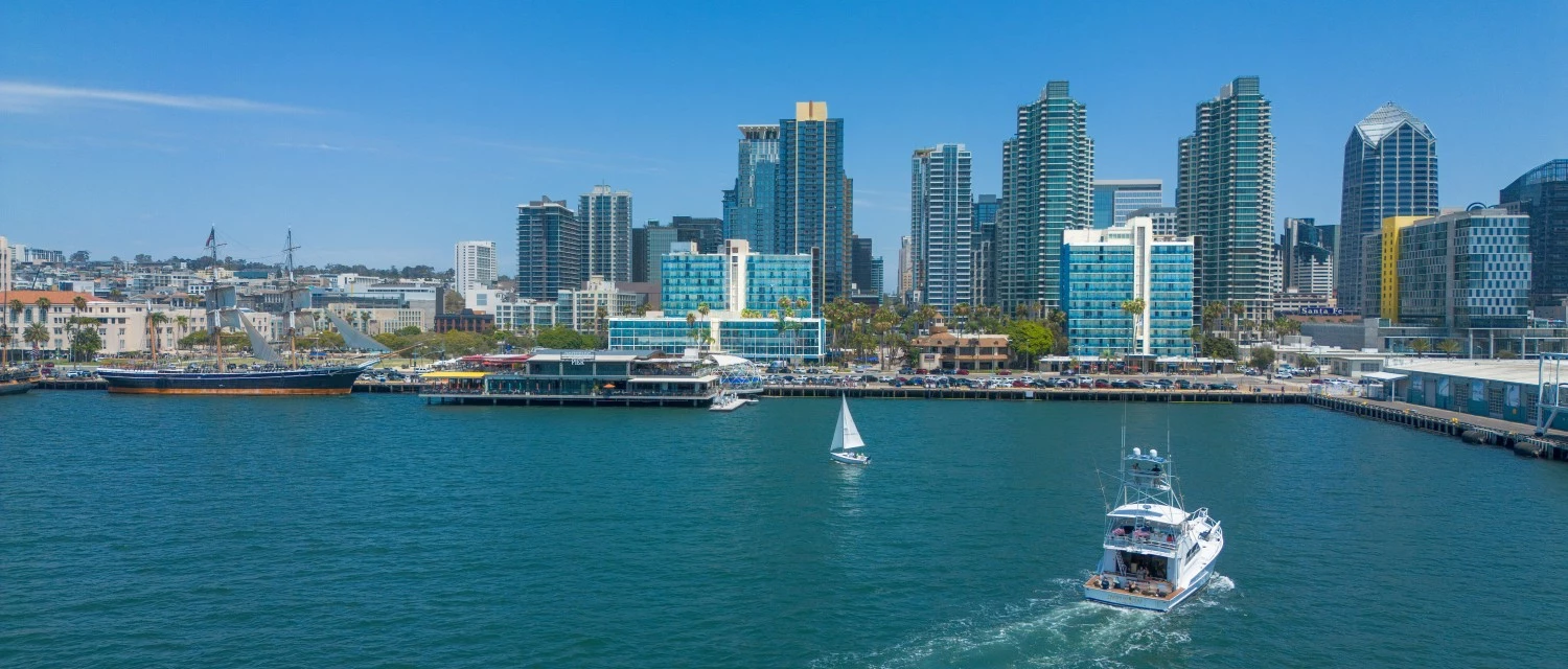 a boat in the water with a city in the background