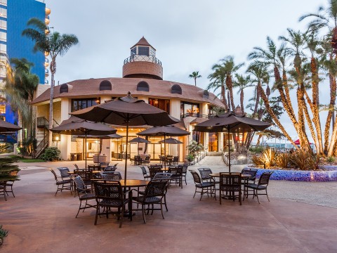 a patio area with umbrellas and tables