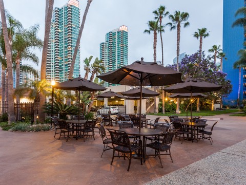 a group of tables and umbrellas in a park