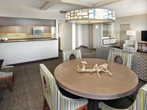 a room with a round table and chairs