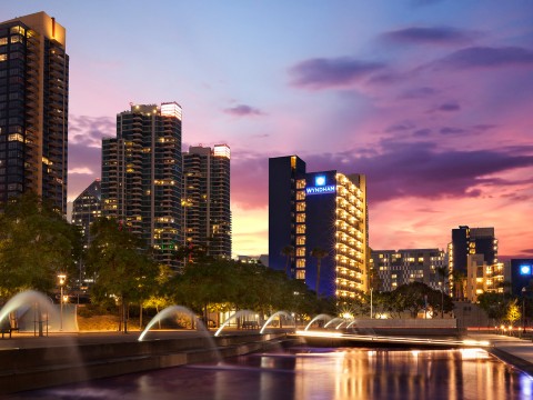 a city skyline with water fountains and trees