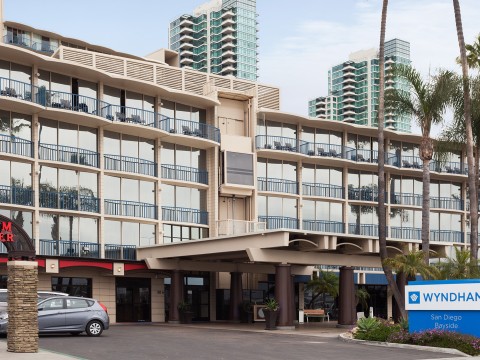 a building with balconies and a parking lot
