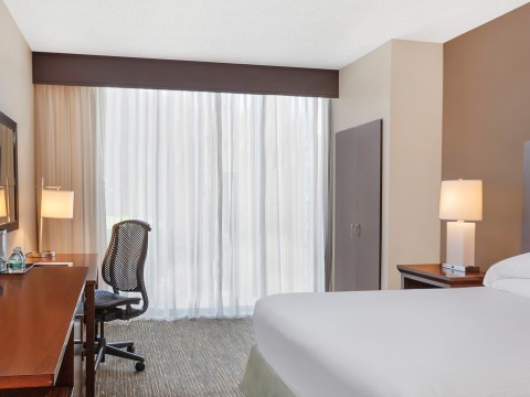 a room with a bed and desk and a chair