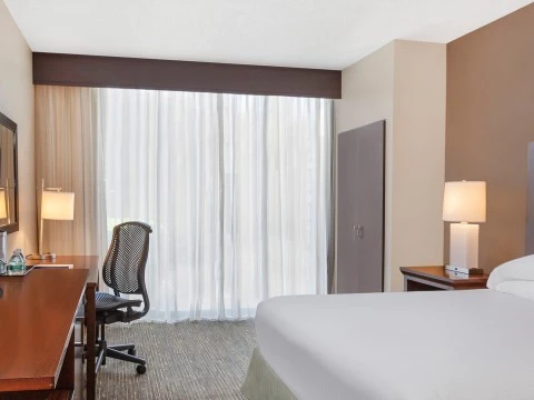 a room with a bed and desk and a chair