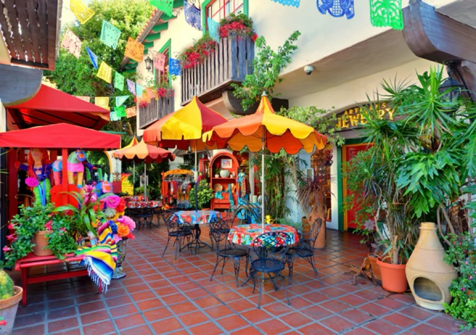 a patio with tables and umbrellas