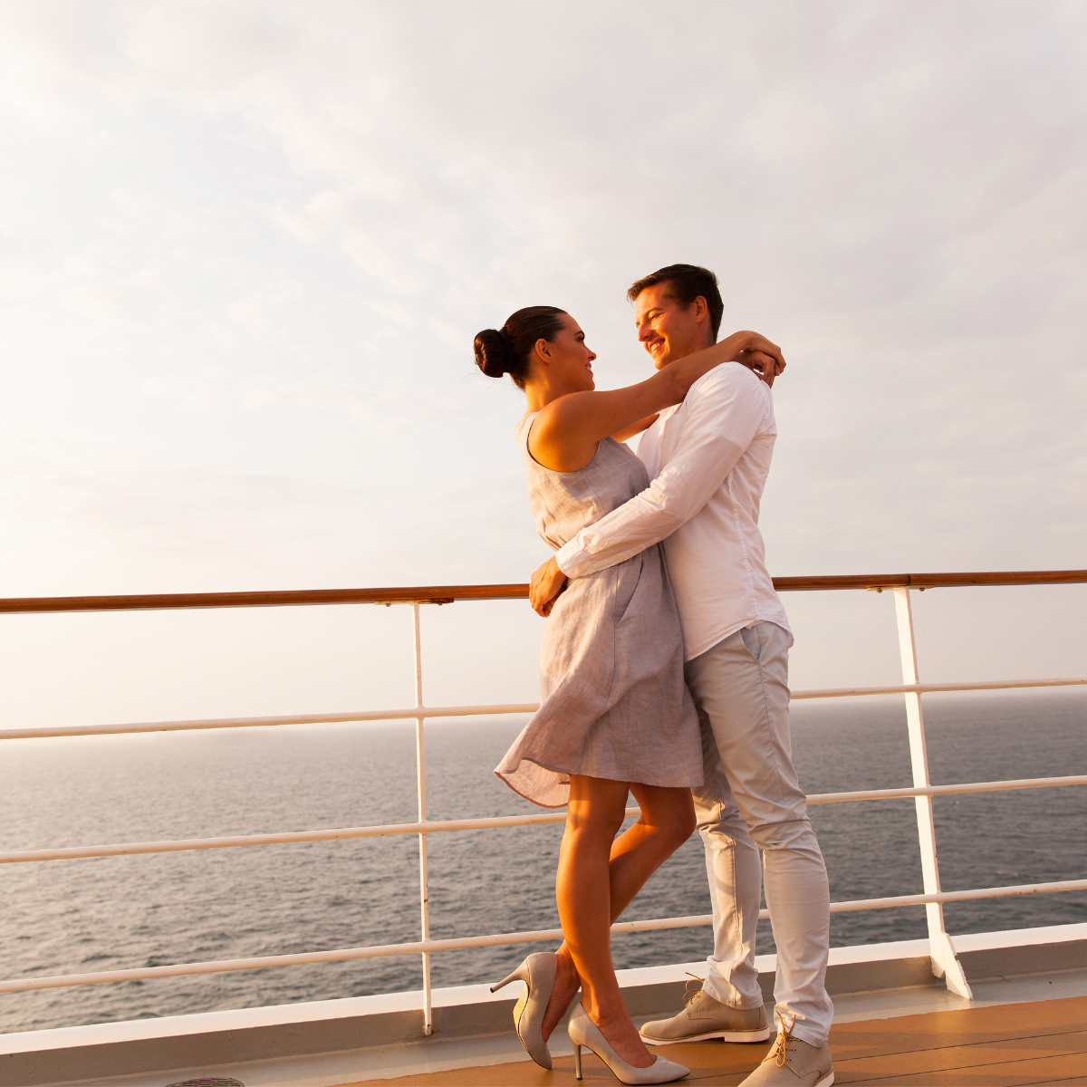 a man and woman hugging on a deck of a cruise ship