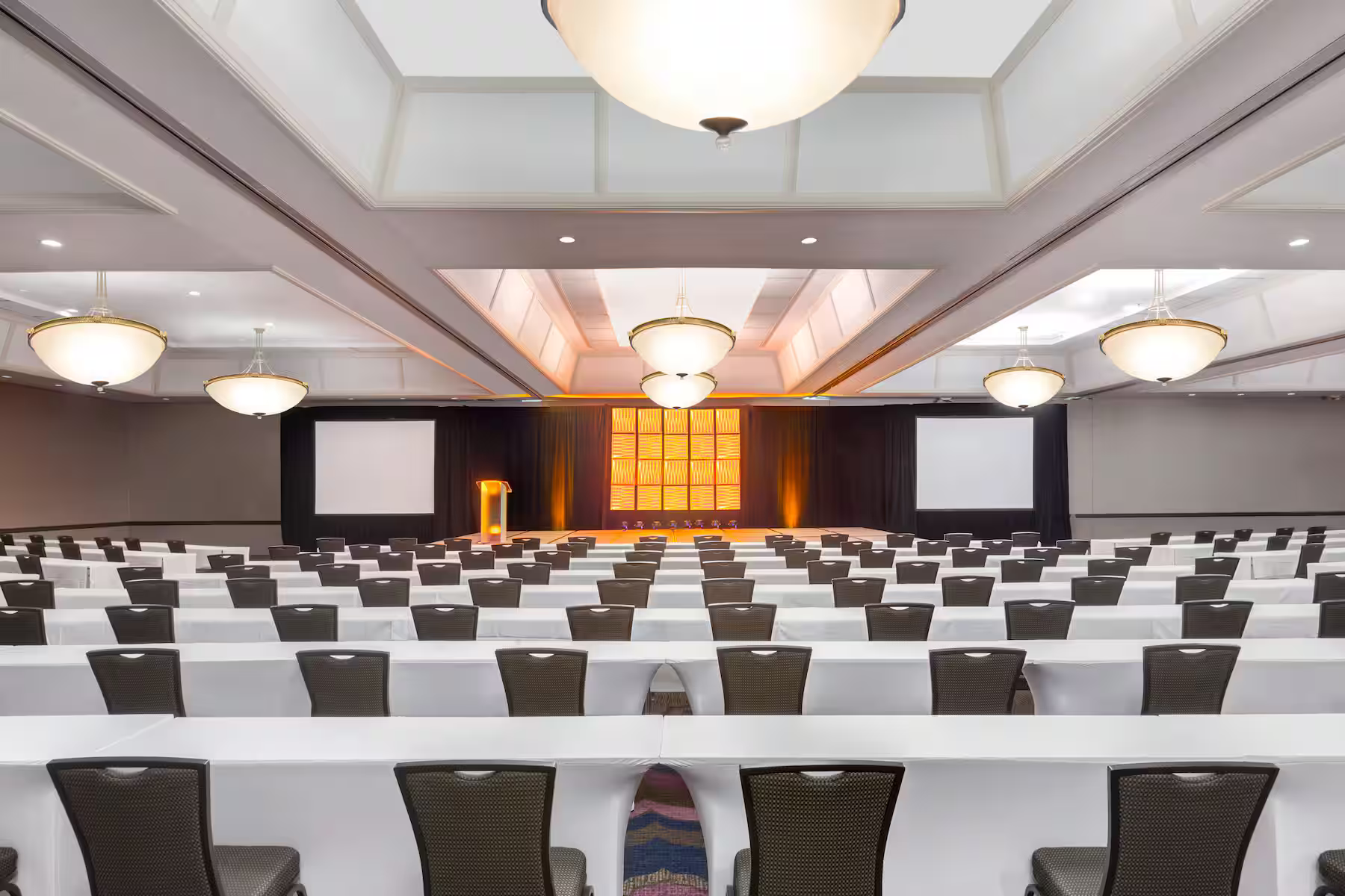 a room with white tables and chairs