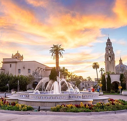 Balboa Park fountain with buildings at sunset