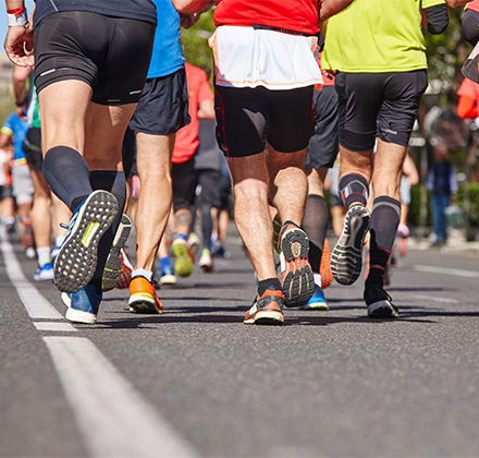 a group of people running on a road