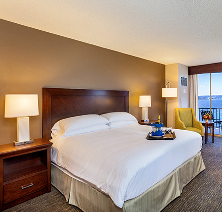 a hotel room with a large bed and a table and chairs