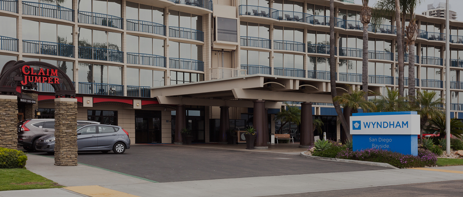 a building with balconies and a parking lot