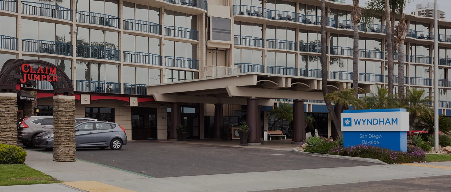 a building with balconies and a parking lot