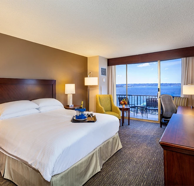 a hotel room with a large bed and a desk