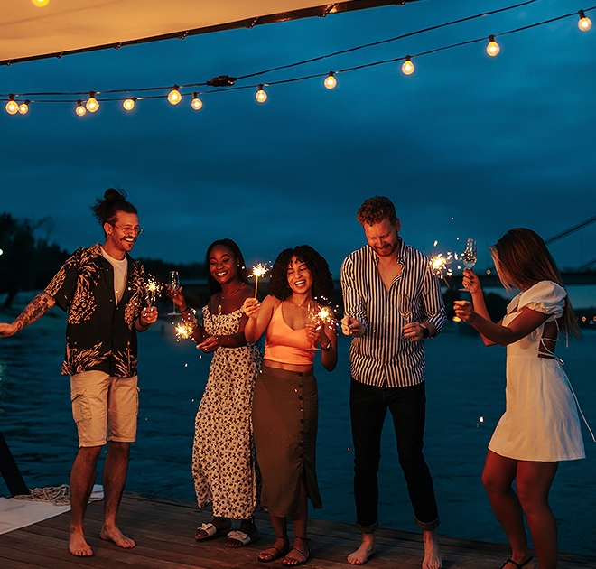 a group of people holding sparklers