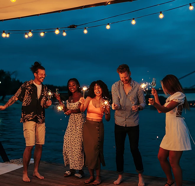 a group of people holding sparklers