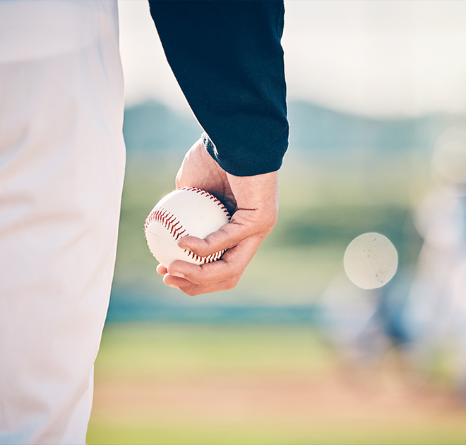 a person holding a baseball