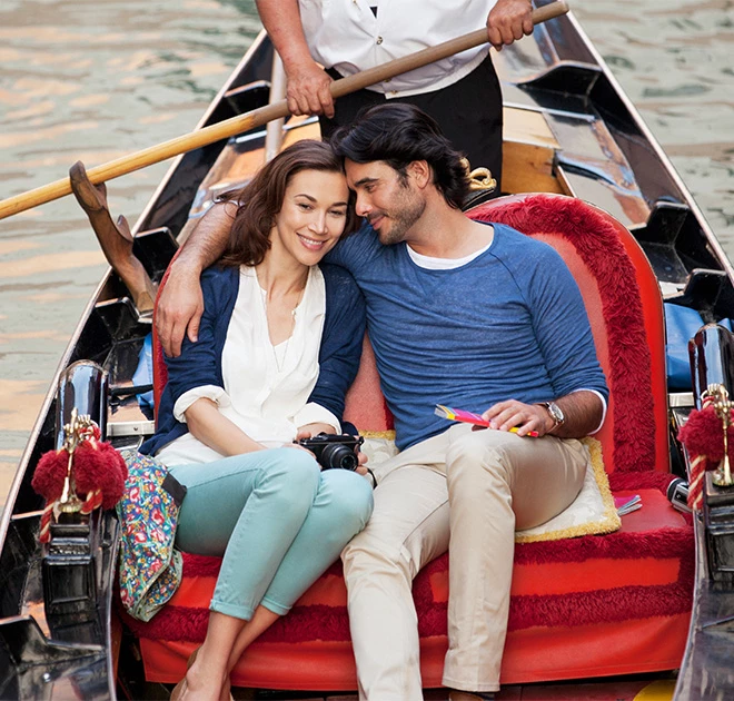 a man and woman sitting in a gondola