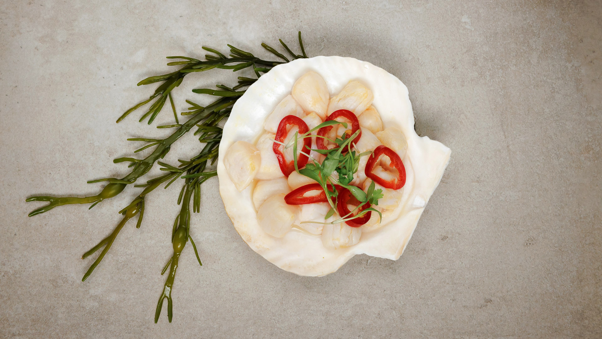a shell with red peppers and greens