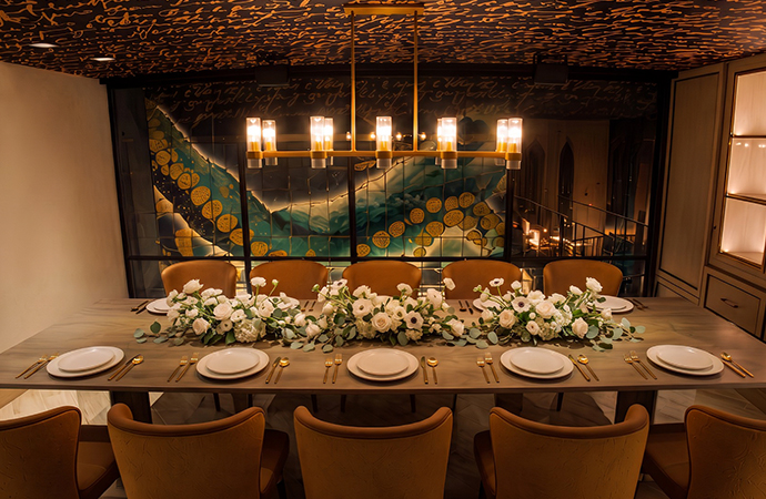 a table with white plates and flowers on it