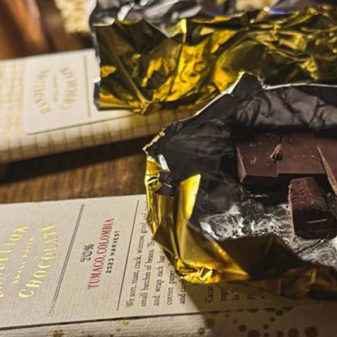 a chocolate in foil and a menu