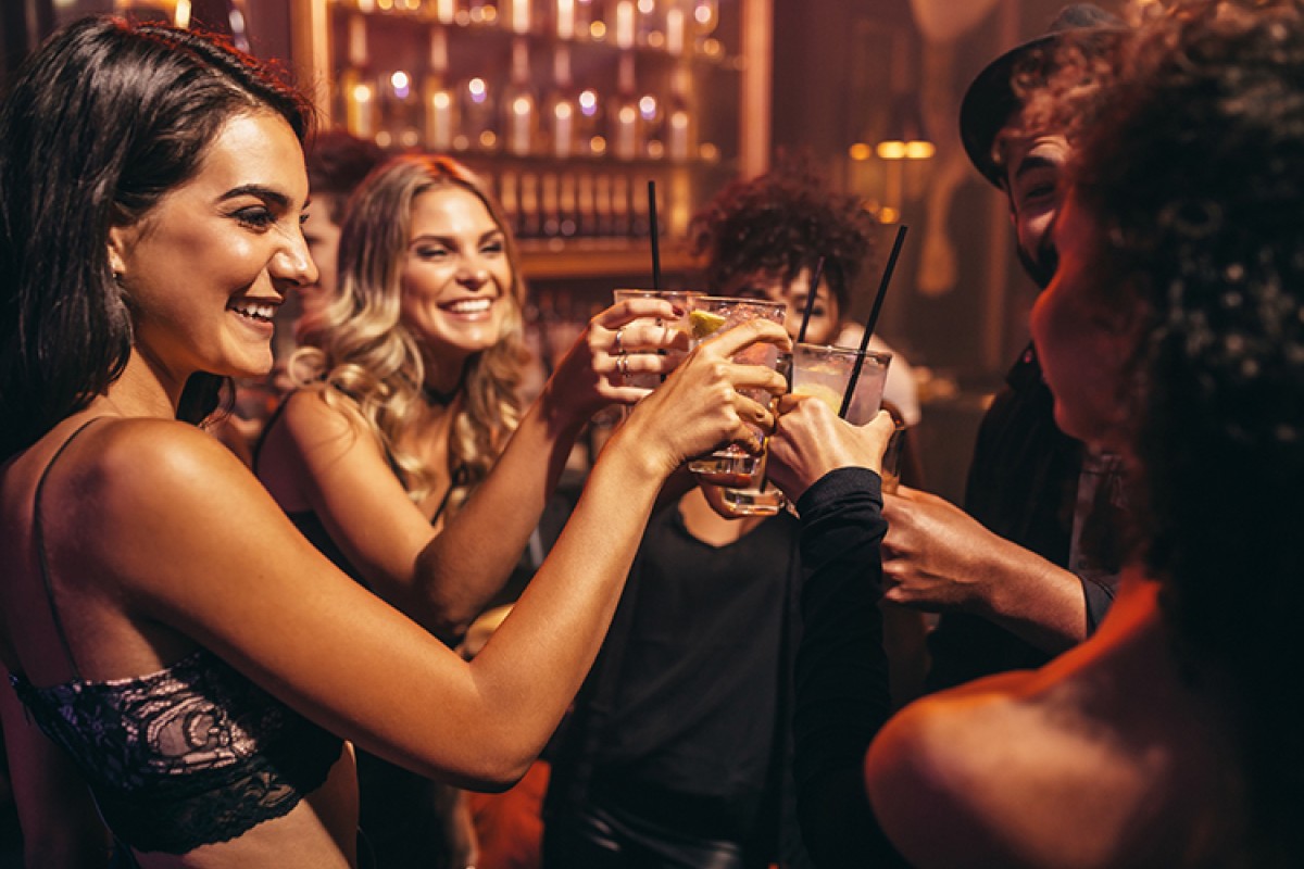 a group of people clinking drinks