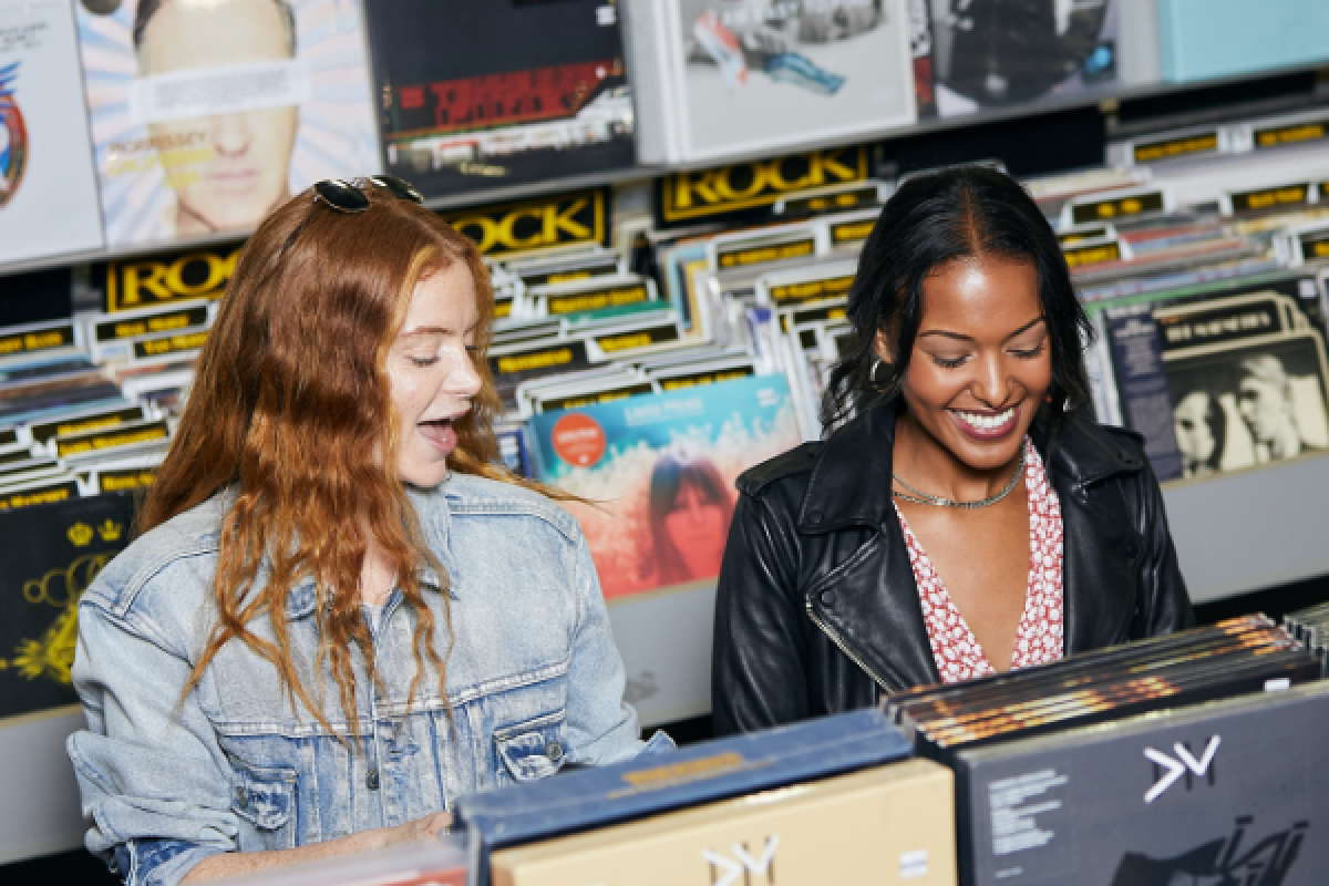 a group of women looking at records
