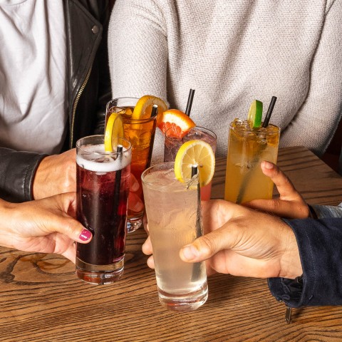 a group of people holding drinks