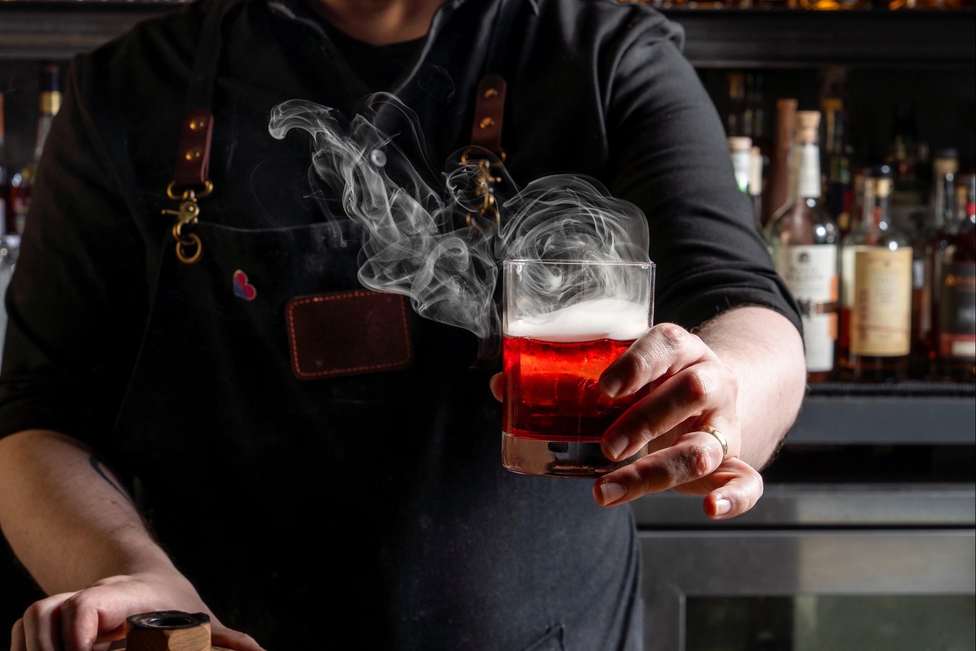 a person holding a glass with a drink