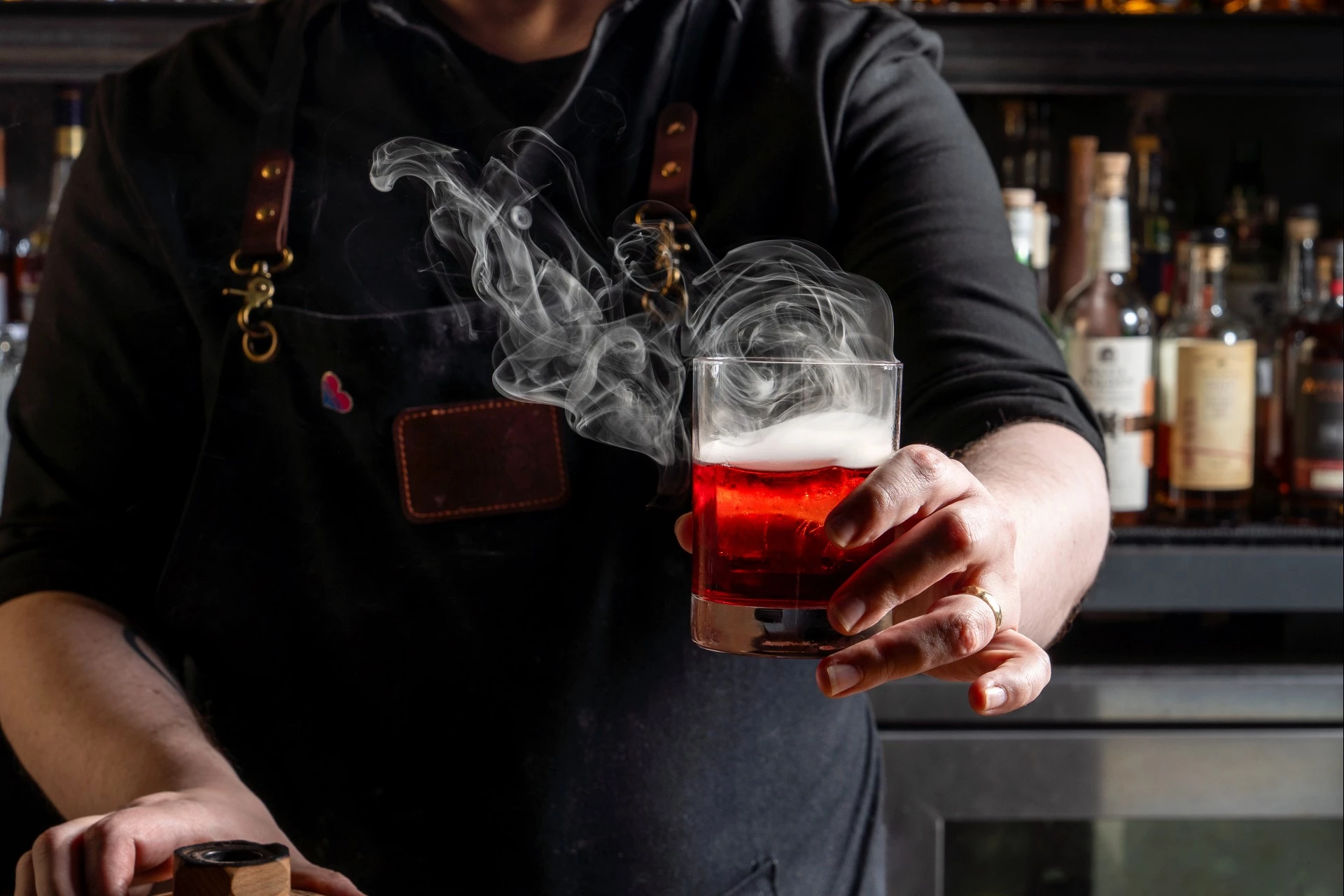 a person holding a glass with a drink