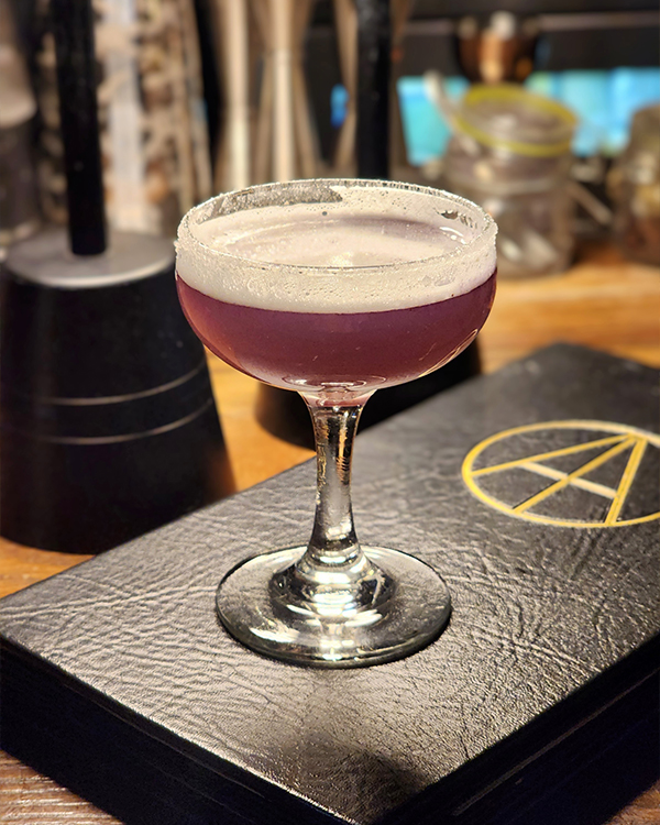 a glass with a purple liquid in it