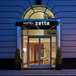 a hotel entrance with a sign