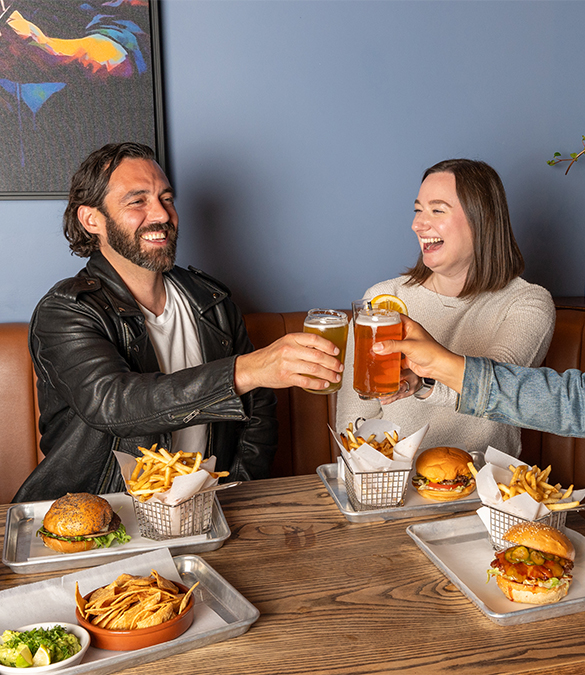 a group of people sitting at a table with food