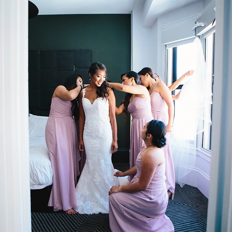 a bride and her bridesmaids in a room