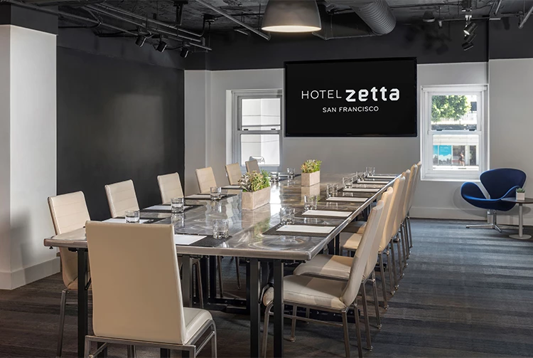a conference room with a table and chairs