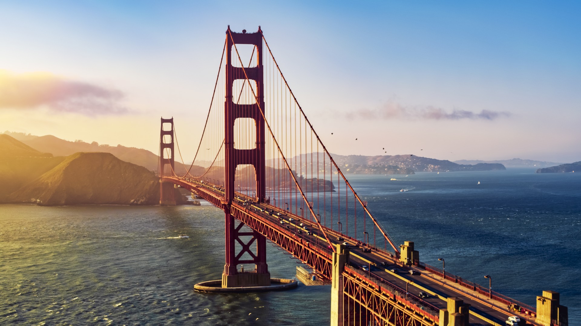 Golden Gate Bridge over water with a large red bridge