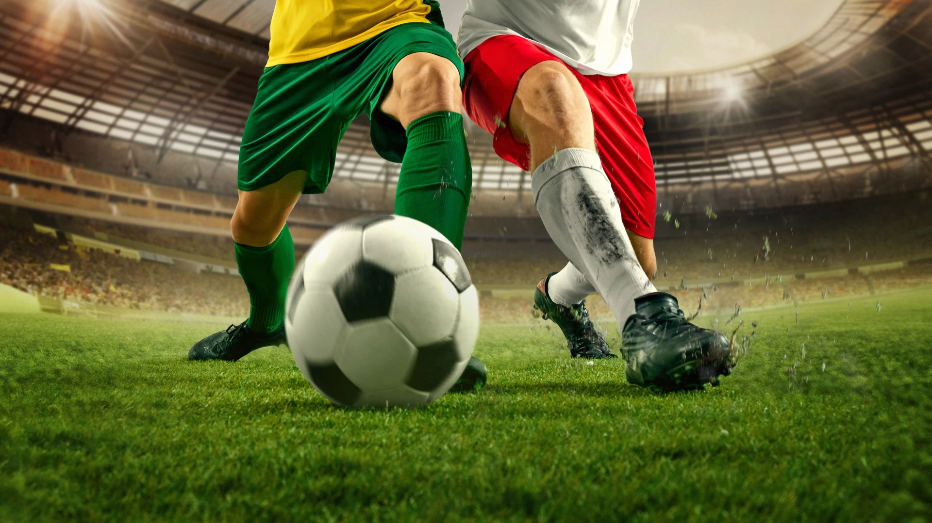 two football players kicking a football ball