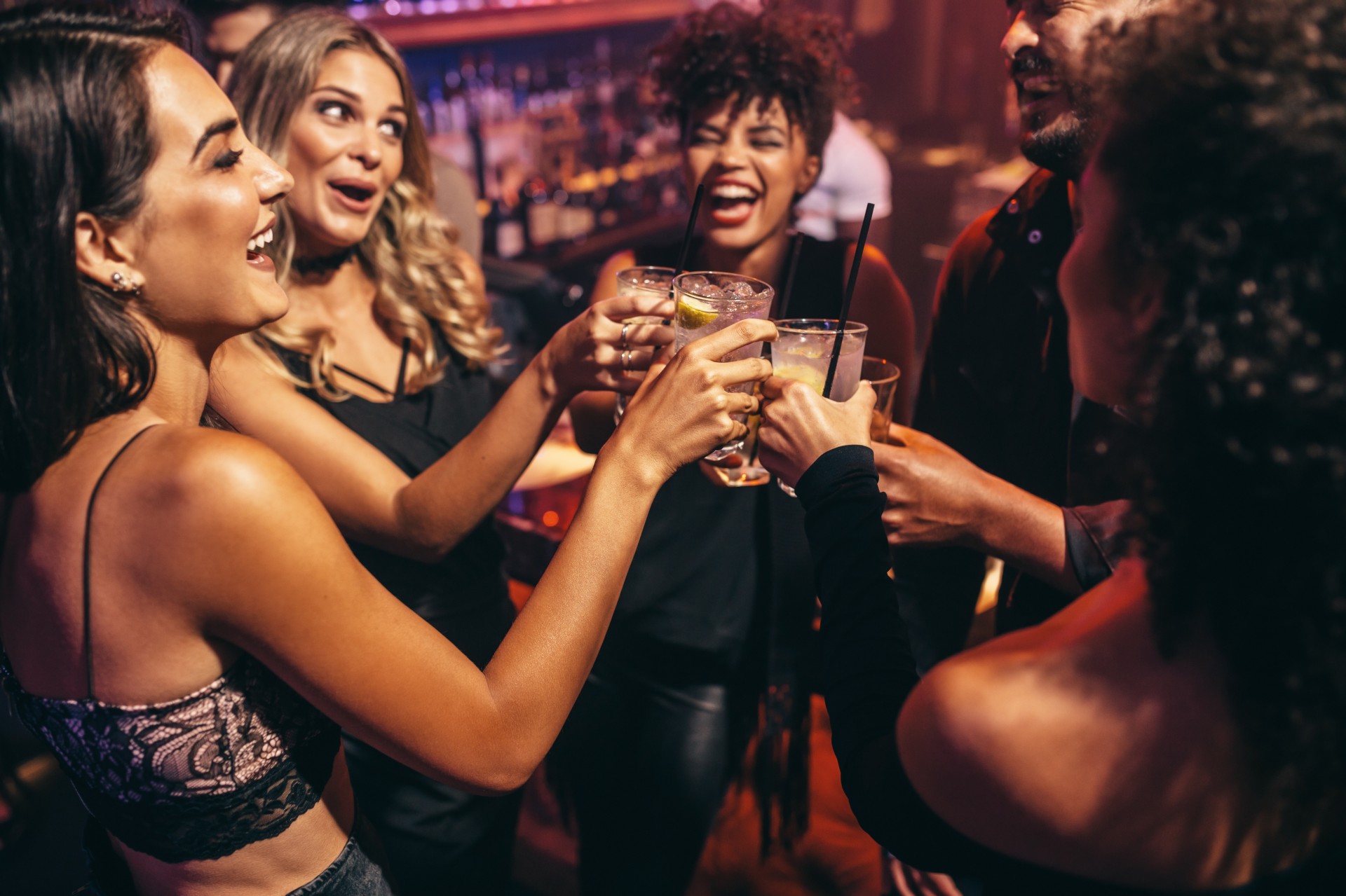 a group of people clinking glasses