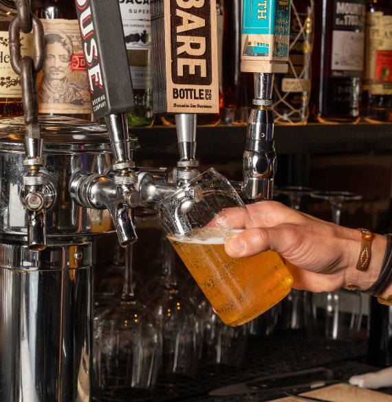 a hand holding a glass of beer