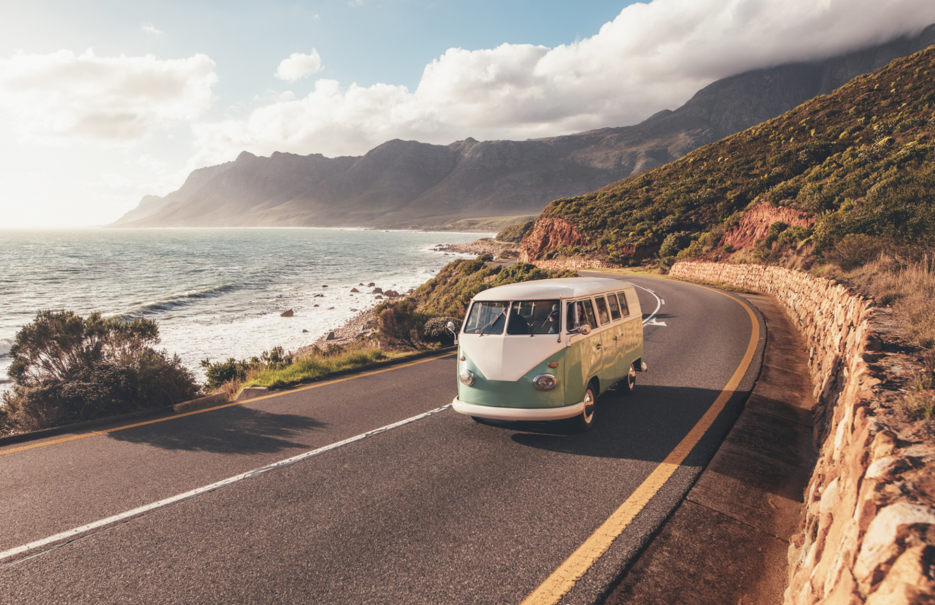a van on the road by the ocean