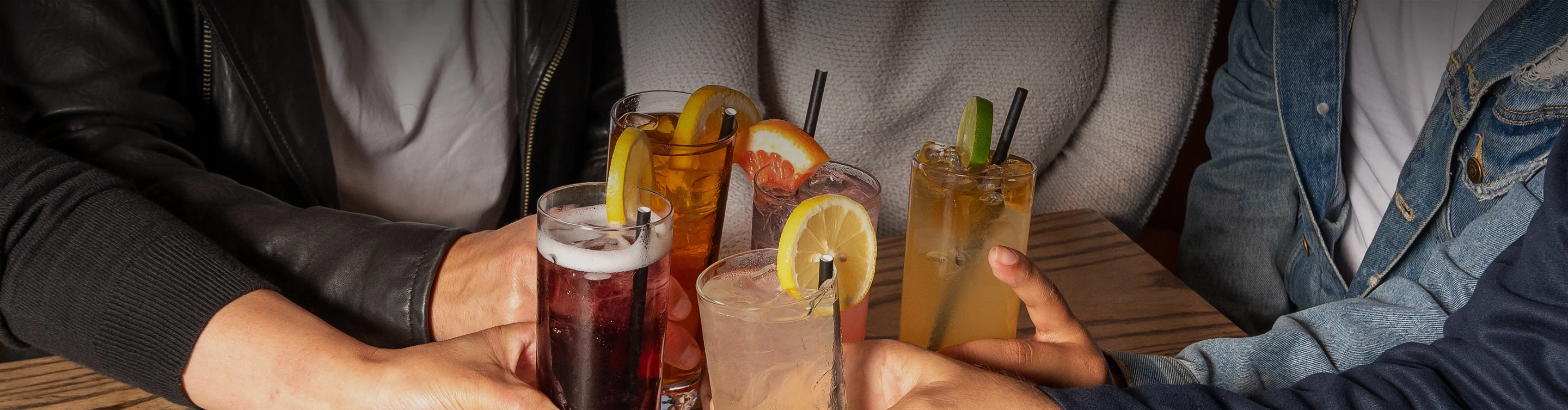 a group of drinks with straws