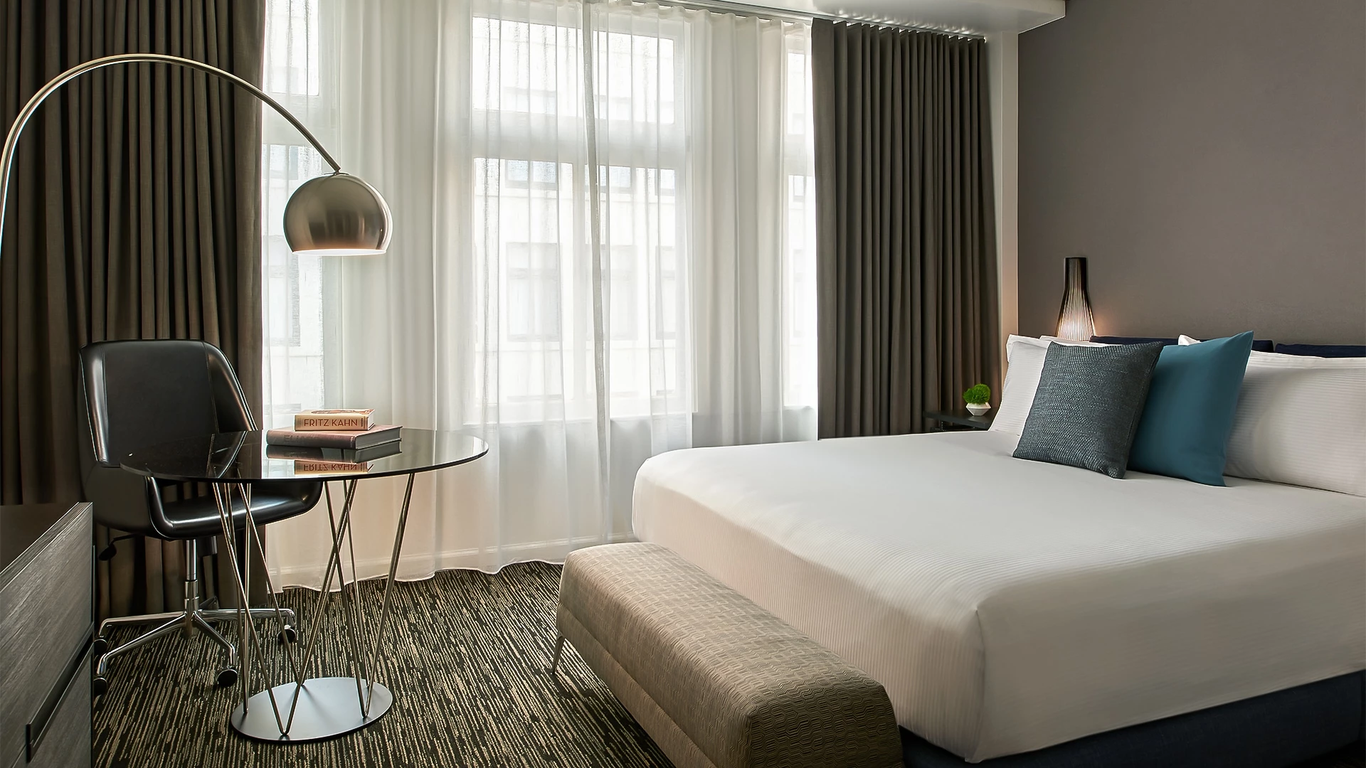 a bedroom with a bed and a table