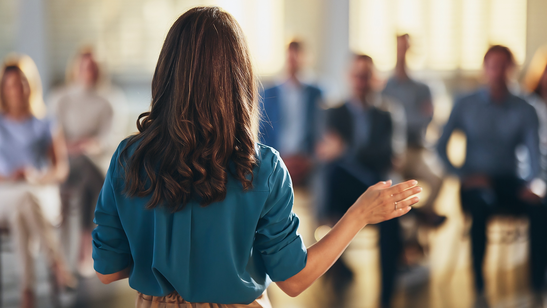 a woman with her hand raised