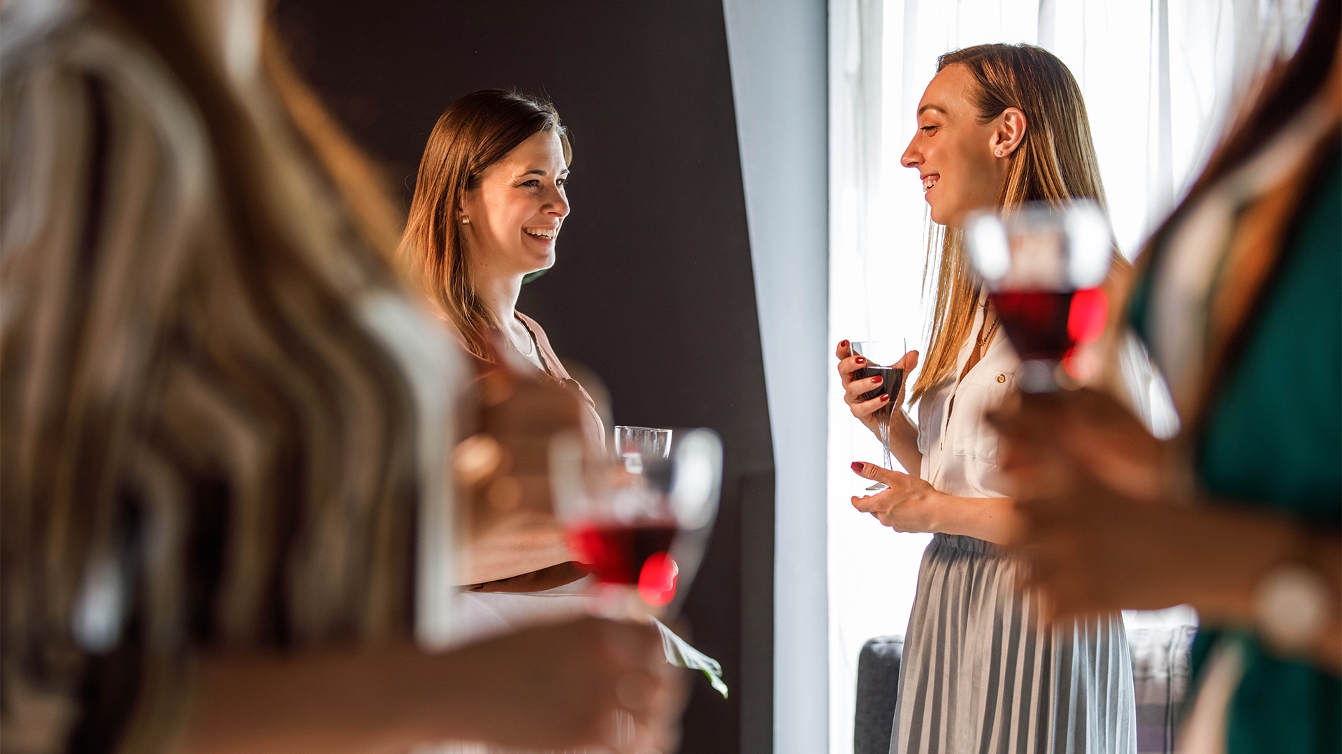 a group of women holding wine glasses
