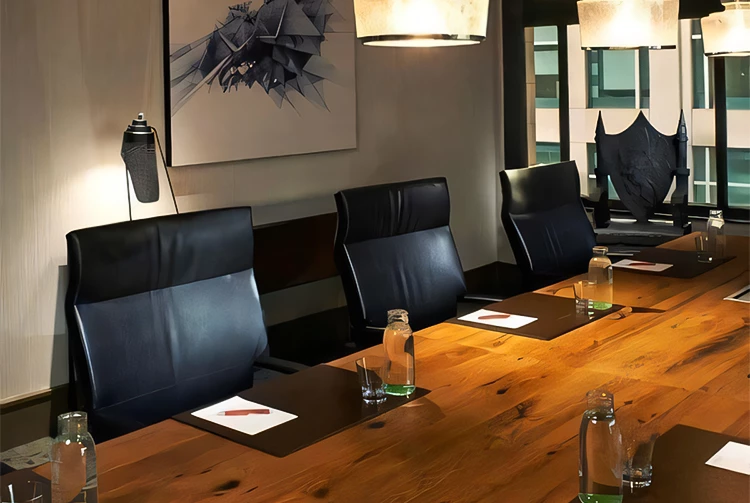 a table with chairs and a picture on the wall