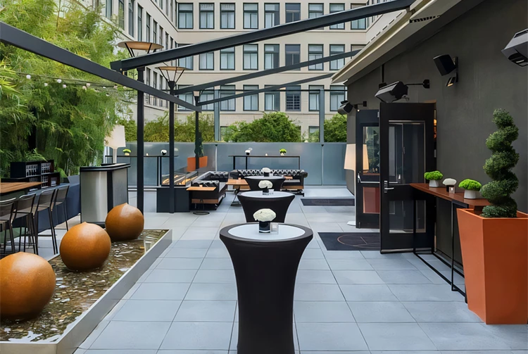 a patio with tables and a fountain