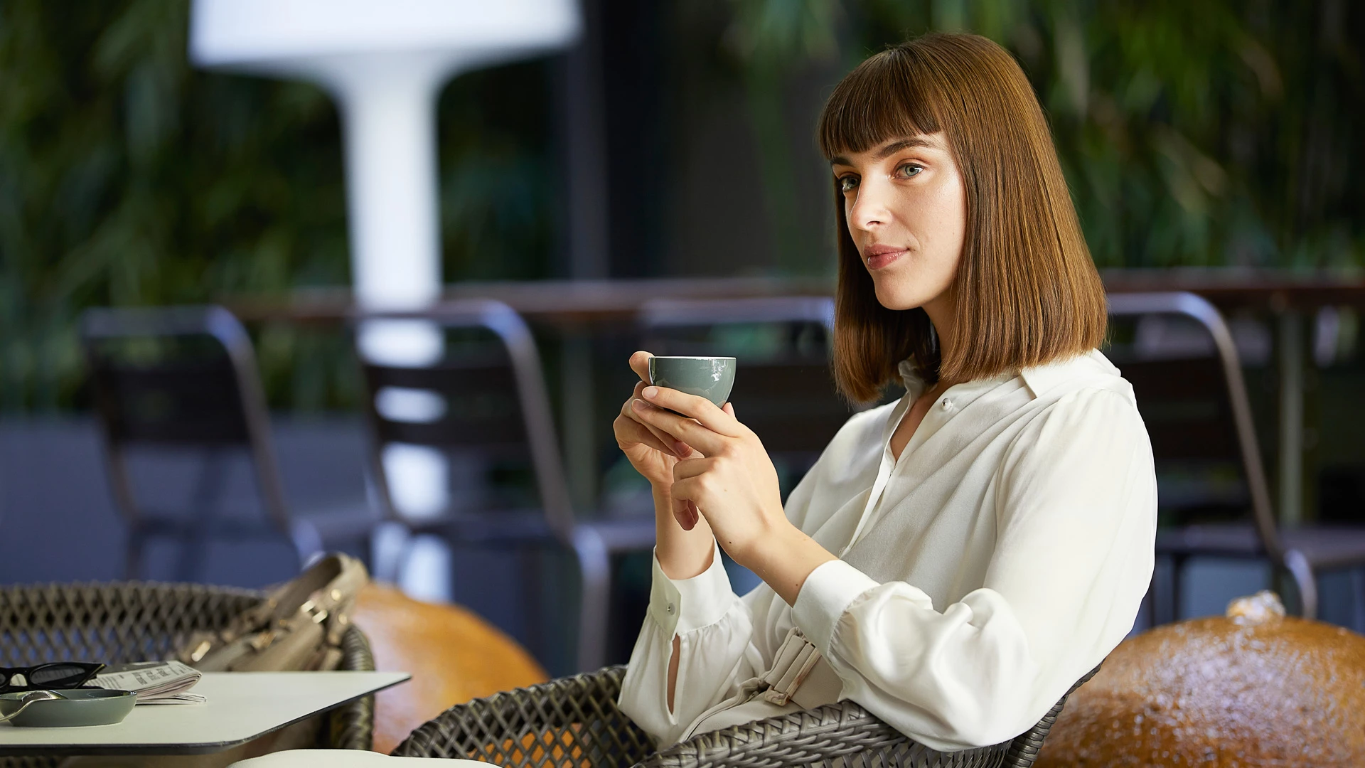 a woman holding a cup