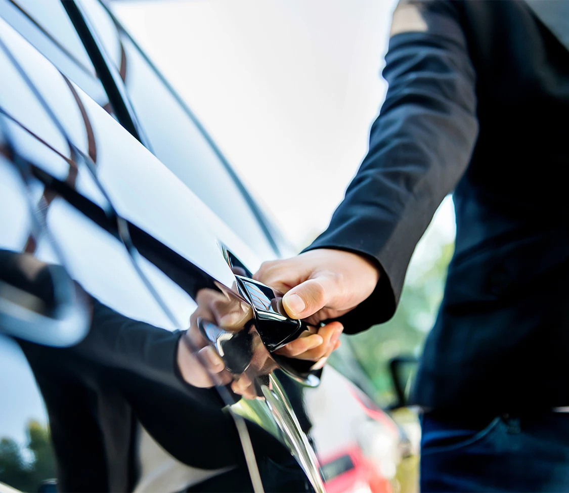 a person opening a car door