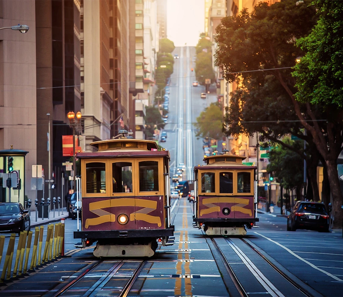 a two trolley cars on a street