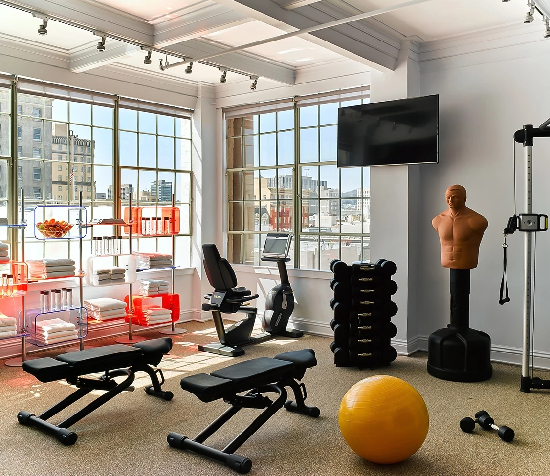 a room with a gym and exercise equipment