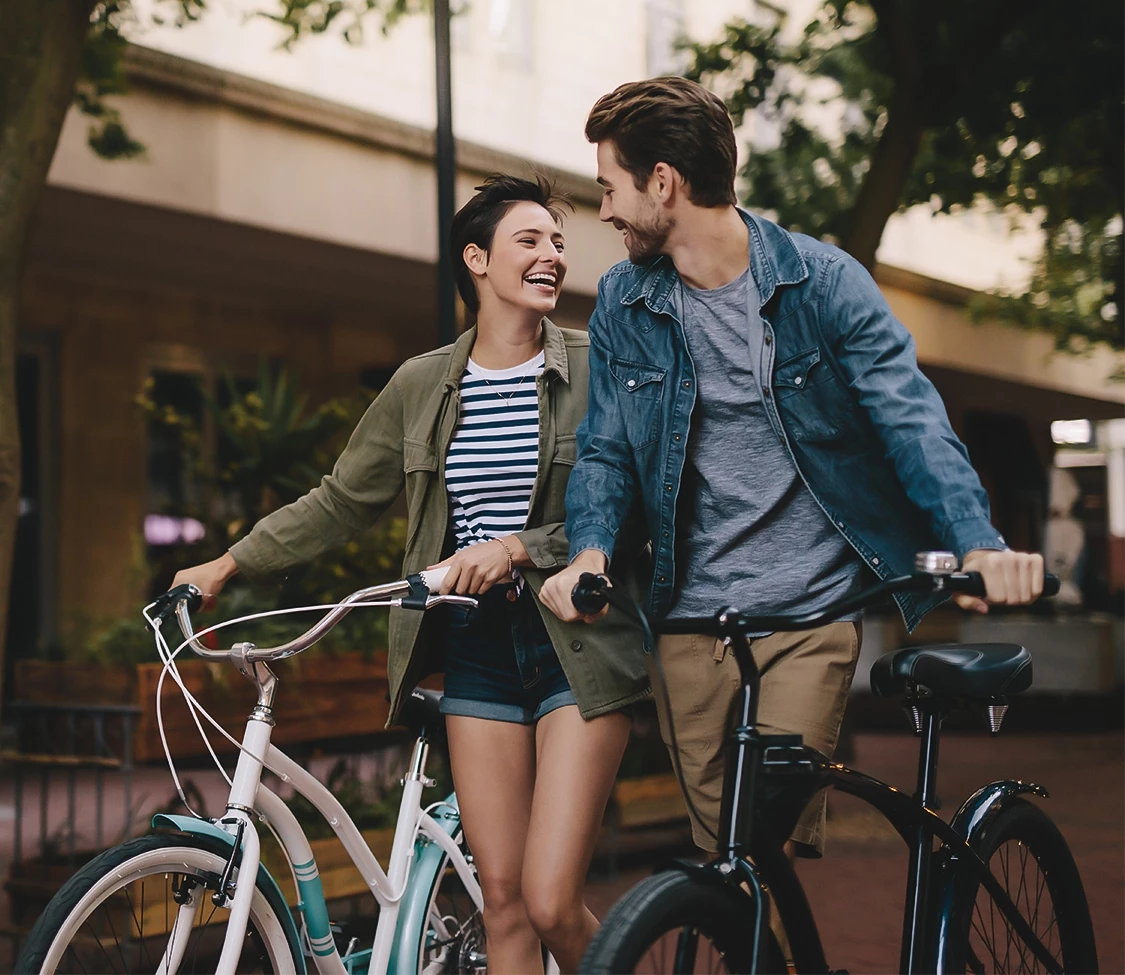 a man and woman standing next to bicycles